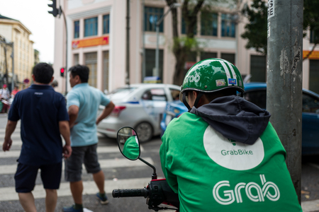 Hanoi, Vietnam - April 15, 2018: Grab driver waits for Clients on the streets of Hanoi.のeditorial素材