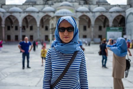 Woman in front of the Sultan Ahmed Mosque in Istanbul, Turkey.の写真素材