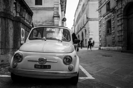 Siena, Italy - September 24, 2020: An old Fiat 500 parking in the old city of Siena.