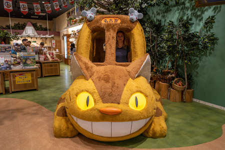 Nagoya, Japan - September 17, 2019: The ghibli cat bus with a caucasian girl in a shop.のeditorial素材