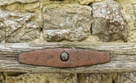 Old farmer working tool on a stone wall