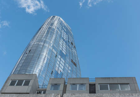 glass and metal office on a sunny day with blue sky and white clouds