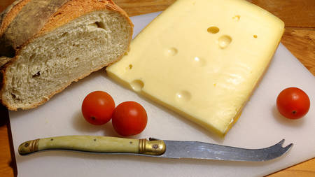 Cheese and home bread with tomatoesの写真素材
