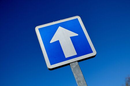 One way only road sign in the street with blue skyの写真素材