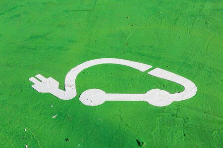 green sign for electric vehicle parking in the ground