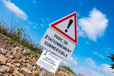 warning sign on Noirmoutier, France slipway for parking one side only and liable to floodingの写真素材