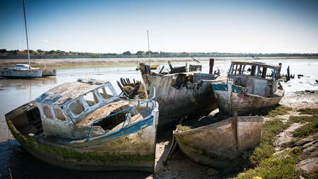Noirmoutier, France - April 28, 2016 : Rustic boats on a ship graveyards on Noirmoutier, France