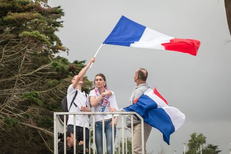 Saint Gilles Croix de Vie, France - July, 10, 2016 : In the fan zone of the city, supporters of Team France waiting for the match of the final of Euro 2016, France - Portugal waving French flags and being dressed in the colors of their countryのeditorial素材