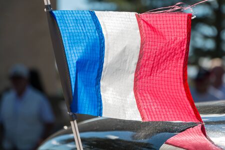 close-up french flag on the roof of a car