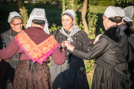 Brem sur Mer, France - July 09, 2016 : old women dance round in a show of traditional dance troupe Vendee region of France, celebrating a weddingのeditorial素材