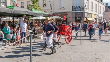 Challans, France - August 11, 2016 : event Once Challans "Autrefois Challans" organized by the city and plunges visitors into the city from the early 20th century - antique firefighters to intervene with a water pumpのeditorial素材
