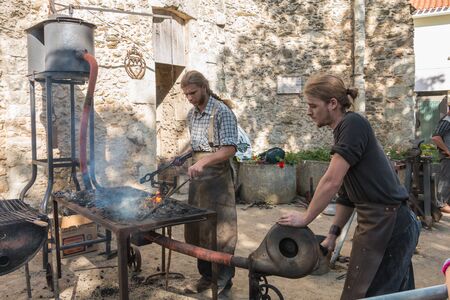 Challans, France - August 11, 2016 : event Once Challans "Autrefois Challans" organized by the city and plunges visitors into the city from the early 20th century - demonstration by two blacksmiths labor metal to the old wayのeditorial素材