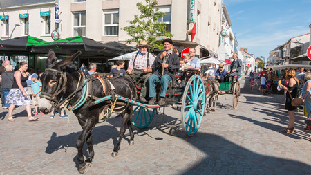 Challans, France - August 11, 2016 : event Once Challans "Autrefois Challans" organized by the city and plunges visitors into the city from the early 20th century - antique cart pulled by a donkey in the streets of the cityのeditorial素材