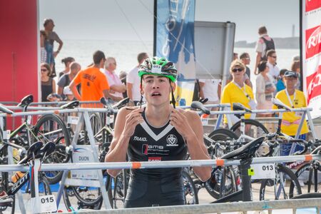 Saint Gilles Croix de Vie, France - September 10, 2016 : Final triathlon championship of France in the category D3 - after exiting the water, athletes take their racing bikeのeditorial素材