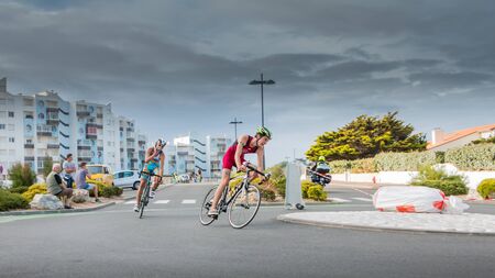 Saint Gilles Croix de Vie, France - September 10, 2016 : Final triathlon championship of France in the category D3 - Cyclists in a curve during a road bike raceのeditorial素材