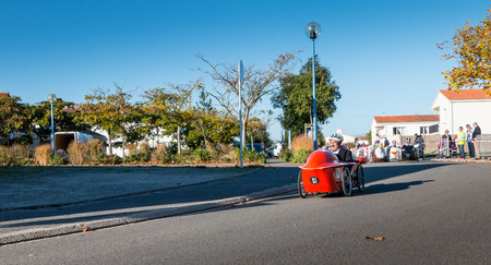 Bretignolles sur Mer, France - October 29, 2016 : old pedal car race organized in city street. Participants are dressed in the colors of their car.のeditorial素材