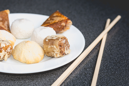 Delicious assortment of homemade Asian pastries. Samosa  and banana ballsの写真素材