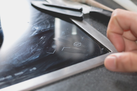 Cook who starts Induction Cooktops in a kitchenの写真素材