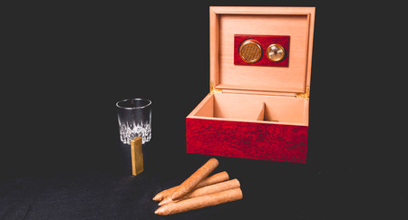 Cigar box on black background and gold lighterの写真素材