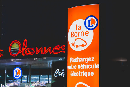 Olonne sur Mer, France - December 03, 2016 : During the Christmas period, at the entrance of the car park of a shop of the "Leclerc" chain in Olonnes sur Mer, France, a panel invites the owners of electric car to recharge their vehicle.のeditorial素材