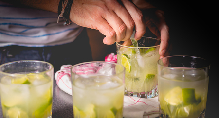 bartender mixes a Brazilian caipirinha with a spoon on a clothの写真素材