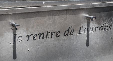 Lourdes, FRANCE, June 22, 2017 - water spigots to fill bottles of holy water near the grotto of lourdes, Franceのeditorial素材