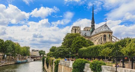Paris, FRANCE - july 11, 2017: Wide shot of Notre-Dame cathedral in Paris, France with its gardens and tourists visiting the French capitalのeditorial素材