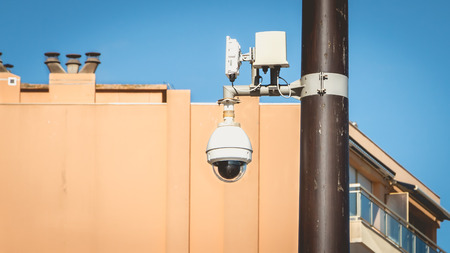 safety camera in white globe hooked on a mat in the city