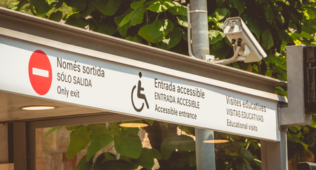 sign indicating in Catalan, Spanish and English - only exit, accessible entrance, educational visits