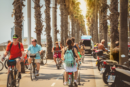 BARCELONA, SPAIN - June 21, 2017 : cyclists cycle on a bicycle path by the sea