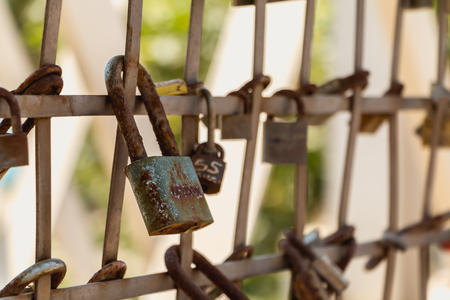 BARCELONA, SPAIN - June 21, 2017 : close up of multiple padlocks that lovers hang on to a grill on the beach to symbolize their loveのeditorial素材