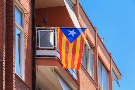 BARCELONA, SPAIN -  June 20, 2017 : example of a building facade in a residential area of the city where floats a Catalan flag on a summer dayのeditorial素材