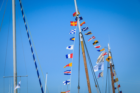 NOIRMOUTIER, FRANCE - August 15, 2016 : set of pennants on the mast of a boat that float in the air on a summer dayのeditorial素材