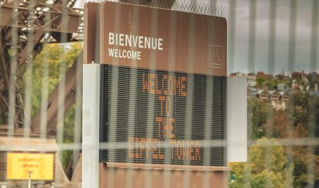 Paris, France - October 08, 2017 : behind barriers of intrusion protection, a panel welcomes visitors to the Eiffel Tower on a fall dayのeditorial素材