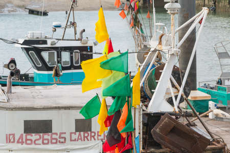 Sables d Olonne, France - March 16, 2017 : closeup of flags hung on floats on fishing boats near starting at the end of winterのeditorial素材
