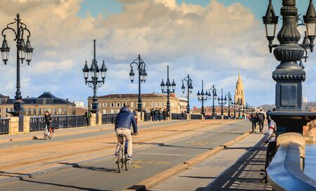 Bordeaux, France - January 26, 2018 : cyclists and pedestrians stroll on the Bordeaux river bridge on a winter dayのeditorial素材