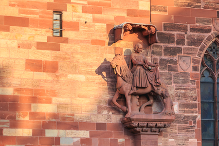 architectural detail of the protestant cathedral of Basel in Switzerland known as the emblem of the cityの写真素材
