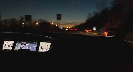 Mulhouse, France - December 25, 2017 : interior view and GPS of a car driving at night on the A36 motorway passing carsのeditorial素材