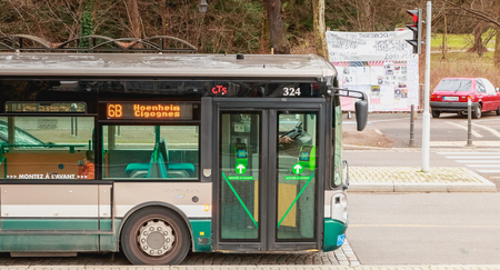 Strasbourg, France - December 28, 2017 : bus of the Strasbourg public transport company (CTS) which is stopped at a bus stop on a winter dayのeditorial素材