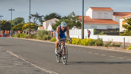 Saint Gilles Croix de Vie, France - September 10, 2016 : runner number 8 which seems to be suffering during the Final triathlon championship of France in the category D3のeditorial素材