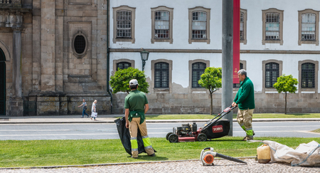 Braga, Portugal - May 23, 2018: Municipal gardeners mowing the grass in the city center on a spring dayのeditorial素材