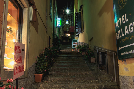 Bellagio, Italy - November 4, 2017: Night street atmosphere with lighting in the city center on a fall dayのeditorial素材