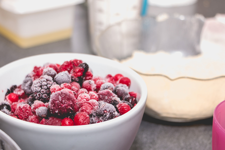closeup of frozen red berries on a kitchen counter in Franceの写真素材