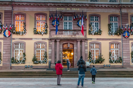 Belfort, France, December 26, 2016: The town hall and the Place d'Armes in Belfort in Franche-Comte that tourists visit on the evening of a winter dayのeditorial素材
