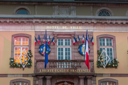 Belfort, France, December 26, 2016: The town hall and the Place d'Armes in Belfort in Franche-Comte that tourists visit on the evening of a winter dayのeditorial素材