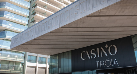Troia, Portugal - August 9, 2018: architectural detail of the marina casino in front of which people are walking on a summer dayのeditorial素材