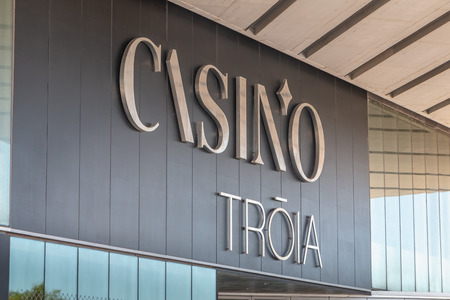 Troia, Portugal - August 9, 2018: architectural detail of the marina casino in front of which people are walking on a summer dayのeditorial素材
