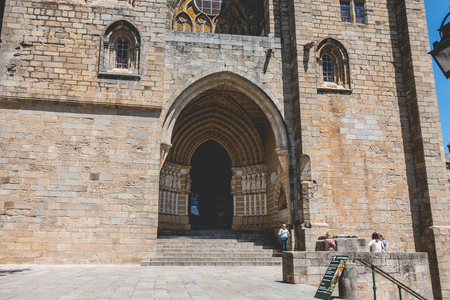 Evora, Portugal - May 5, 2018: People walk in front of the Cathedral Basilica of Our Lady of the Assumption of Evoraのeditorial素材