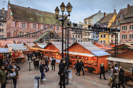 Mulhouse, France - December 23, 2017: Christmas market in front of the cathedral where people are walking on a winter dayのeditorial素材