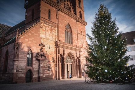 Basel, Switzerland - December 25, 2017: Architectural detail of the protestant cathedral emblem of the city decorated for Christmasのeditorial素材